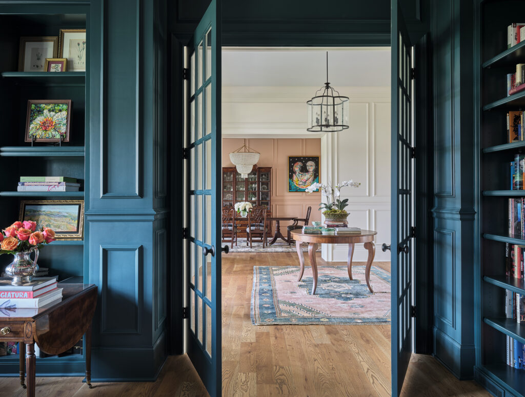 A beautiful home designed by Miller House Interiors featuring soft blue French doors opening into a classic living space with a refined color scheme and elegant furniture.